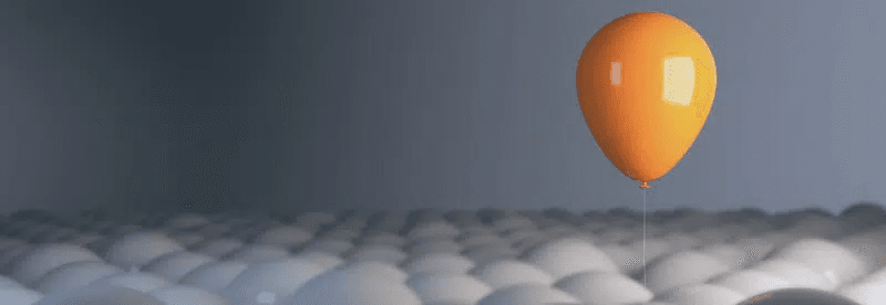yellow balloon floating above white balloons